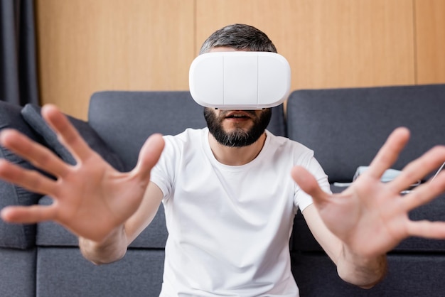 Selective focus of man using vr headset in living room