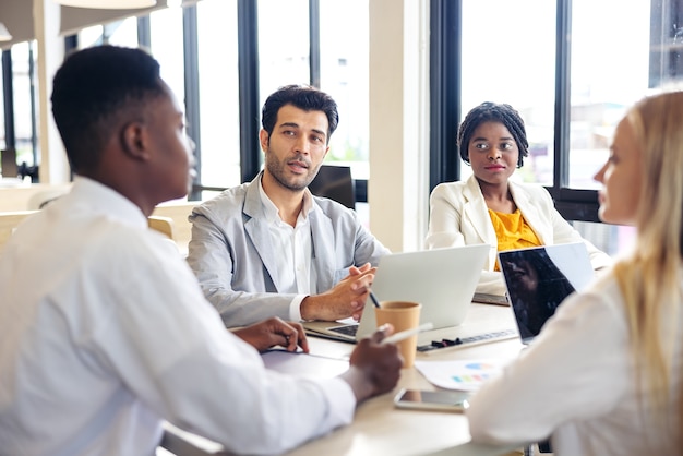 Selective focus of Multi-ethnic group of young people studying together