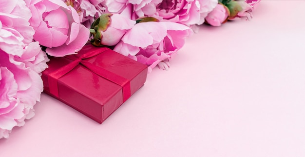 Selective focus over peonies and gift box