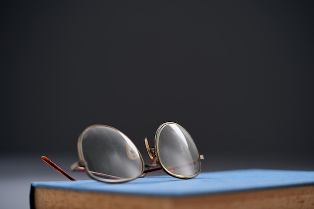 Selective focus on reading glass and old book