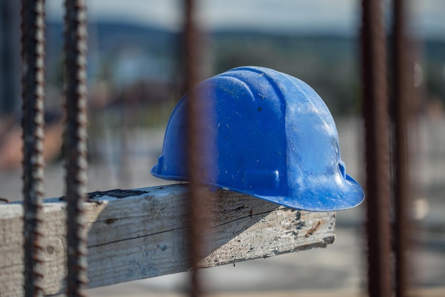 Selective focus shot of the blue construction safety helmet at a construction site