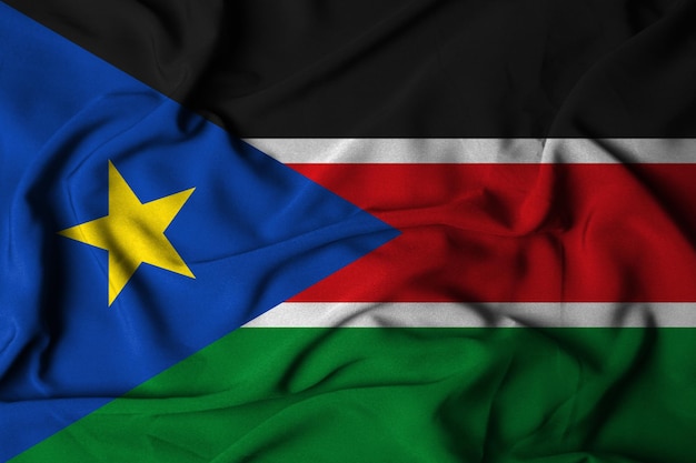 Selective focus of south sudan flag, with waving fabric texture. 3d illustration