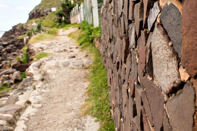 Selective focus on stone wall with blurred path