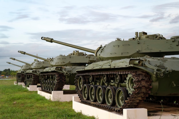 Selective focused of historic green army tanks parking on green grass field