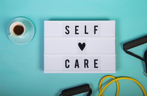 Self care word on lightbox on blue background Take care of yourself