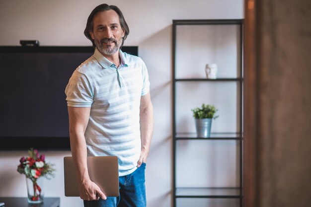 Self-employed. Determined dark-haired man with a laptop