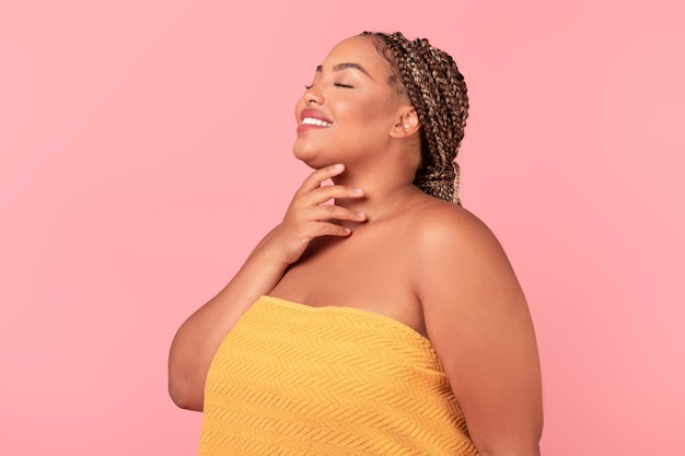 Self love and acceptance concept Portrait of happy black chubby woman with perfect skin enjoying her natural beauty