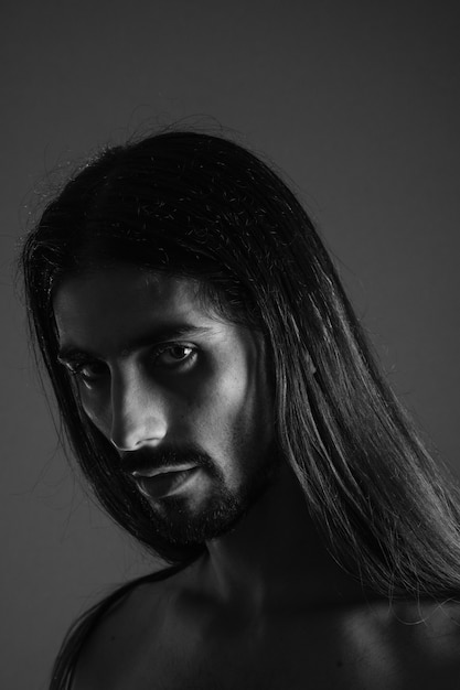 Self-portrait of a young man with long hair in black and white