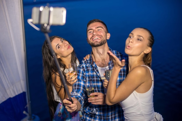 Selfie on the background of the lake friends make the selfie night embankment