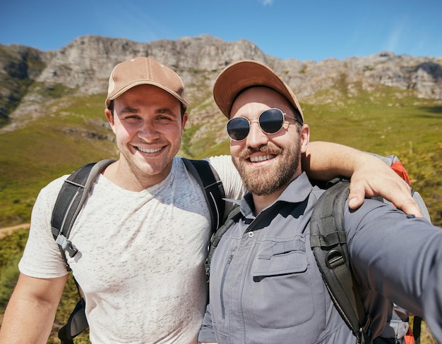 Selfie of happy hiking men or friends in mountains or nature on vacation holiday travel in summer or spring together Portrait of young tourist people smile or smiling on a trekking adventure trip