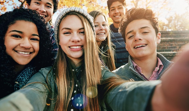 Photo selfie smile and gen z friends in a park happy bonding and having fun outdoor together portrait profile picture and teenager group enjoy the weekend in a forest for vacation holiday or chilling