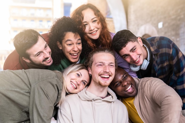 Selfie of young smiling teenagers having fun together outside