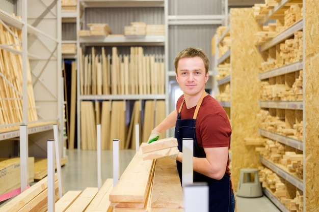 Seller in construction store with wood