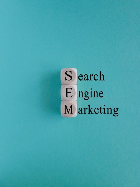 SEM search engine marketing symbol Wooden cubes with words 'SEM on blue backround