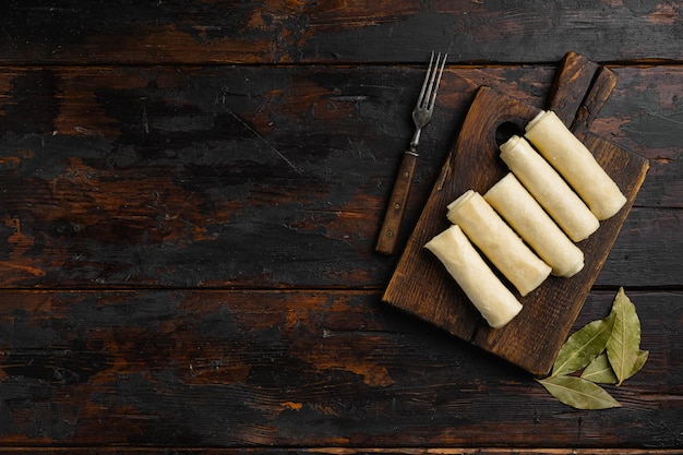 Semi finished pancakes on old dark wooden table background top view flat lay with copy space for text