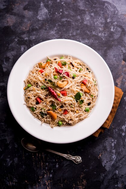 Semiya Upma or Vermicelli Uppuma or uppittu is a popular breakfast menu from south India. served in a bowl. selective focus