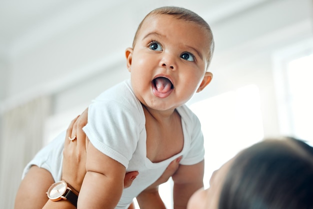 Sending some baby fever your way Shot of a woman holding up her adorable baby boy