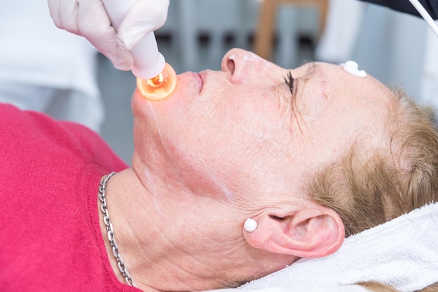 Senior adult woman light skin in a spa removing wrinkles