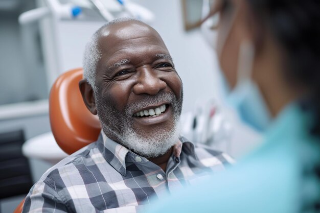 Senior African American man talking to his dentist during appointment at dental clinic