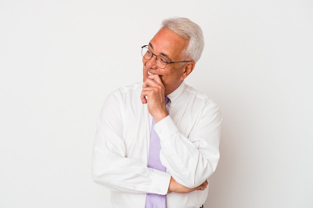 Senior american man isolated on white background relaxed thinking about something looking at a copy space.