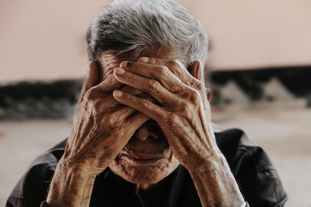 Senior asian man covering his face with his hands Depression and anxiety Copy space