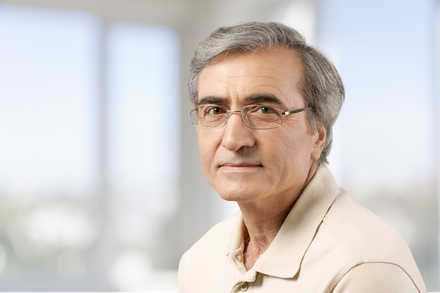 Senior business man in grey suit on light background