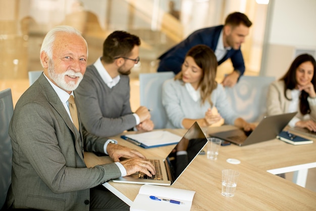 Senior business man working on digital tablet in the office