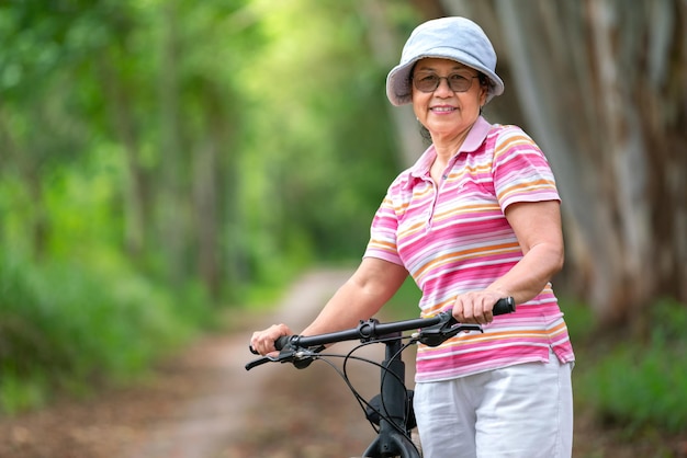 Senior business woman female ride or bike mountain bicyclefor healthy exercise in summer weekend