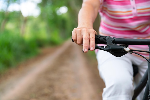 Senior business woman female ride or bike mountain bicyclefor healthy exercise in summer weekend