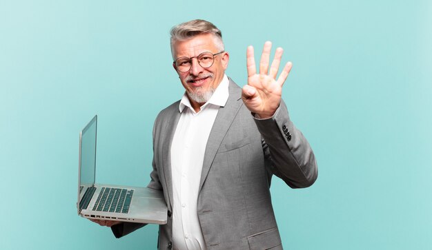 Senior businessman smiling and looking friendly, showing number four or fourth with hand forward, counting down