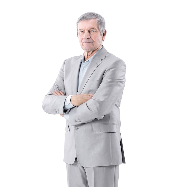 Senior businessman standing with arms crossed on white background