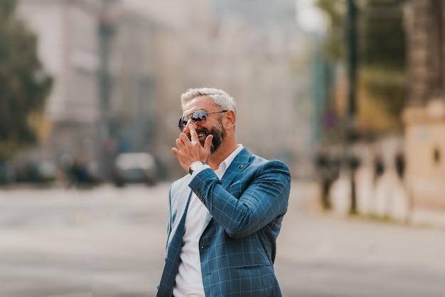 A senior businessman in a suit walking around the city after work