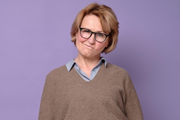 Senior caucasian woman in glasses thinking puzzled about her choice