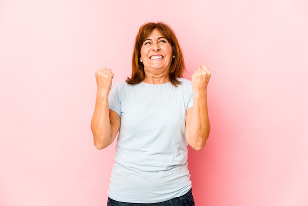 Senior caucasian woman isolated celebrating a victory, passion and enthusiasm, happy expression.