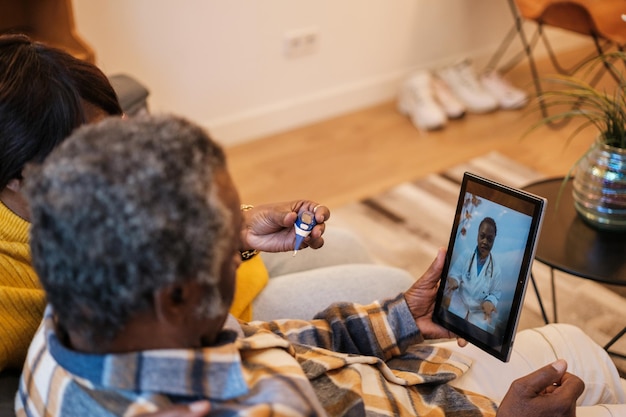 Senior couple assisted online by their doctor to preserve the health of the elderly Concept telecommuting health care illness