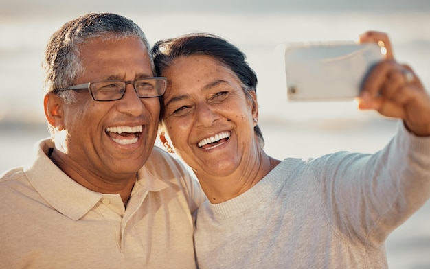 Senior couple beach selfie and summer sunshine with happiness for travel blog and post on web Old man woman and smile for photography on romantic vacation profile picture and social network app