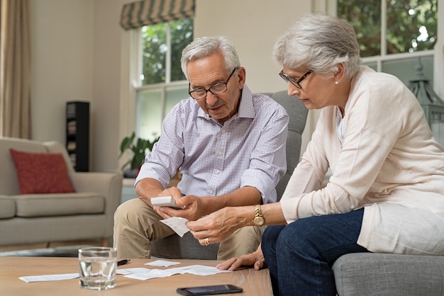 Senior couple calculating expenses