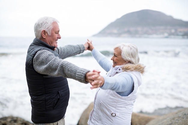 Senior couple having fun together at beach