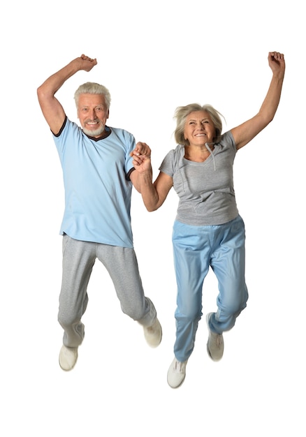 Senior couple jumping  on a white background