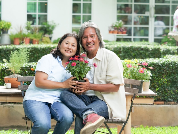 Senior couple laughing together in home garden.