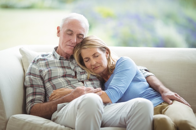 Senior couple relaxing on sofa in living room