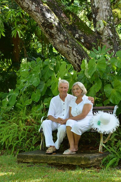 Senior couple sitting at bench