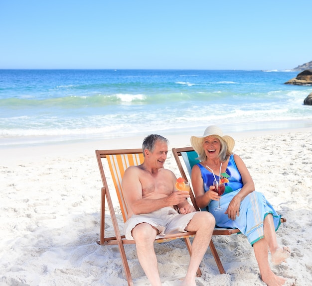 Senior couple sitting on deck chairs