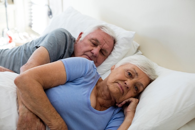 Senior couple sleeping in the bedroom at home