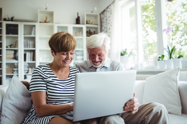 Senior couple using laptop