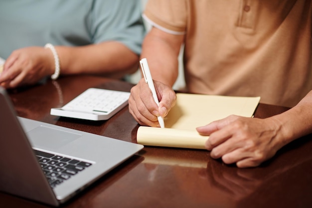 Senior Couple Writing down Expenses