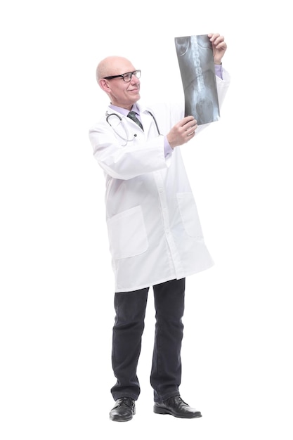 Senior doctor with a stethoscope looking at an x-ray. isolated on a white background.