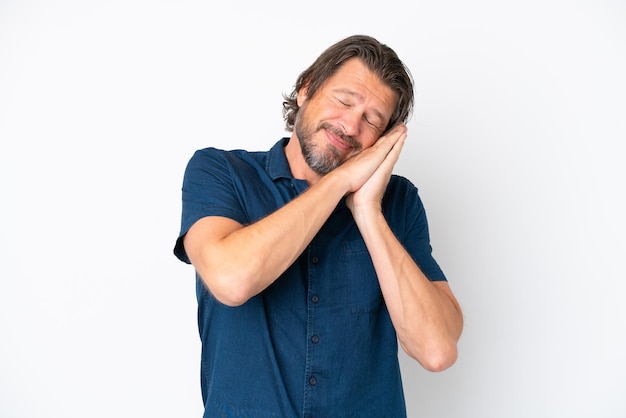 Senior dutch man isolated on white background making sleep gesture in dorable expression