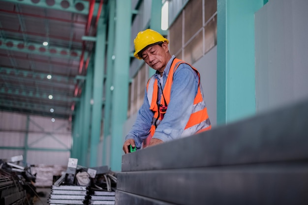 Senior engineer working inside the building of a manufacturing plant industrial plant