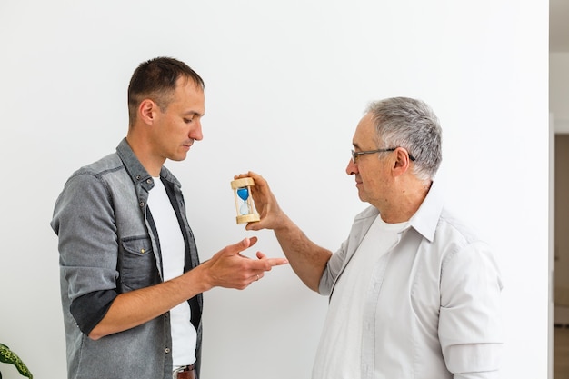 Senior Father With Adult Son isolated on white wall